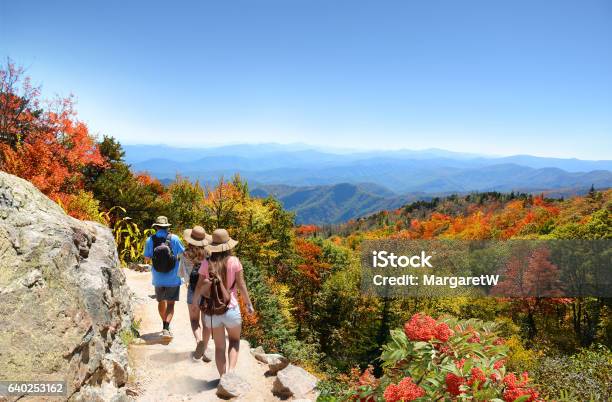 Family Hiking On Vacation In Autumn Mountains Stock Photo - Download Image Now - Hiking, Vacations, Family