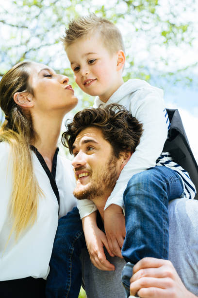istock Mother Kissing Goodbye Husband And Son Before Going To Work 640253198