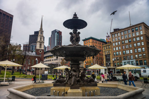 Boston, United States - April 27, 2015: Fountain at Boston Common public park in downtown Boston, Massachusetts, the United States. Park Street Church and People on the background