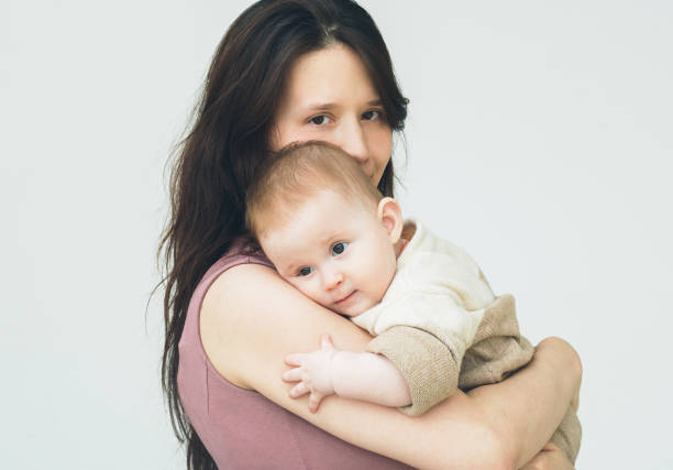 istock Baby with mother. Studio shot. Isolated on white. 640254960