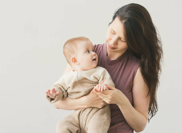 istock Baby with mother. Studio shot. Isolated on white. 640255340