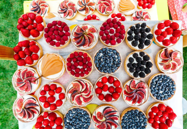 istock Fruit and Berry tarts dessert assorted top view background 640255572