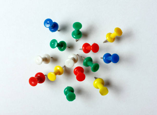 istock Many colored thumbtacks stuck into a white sheet 640258278