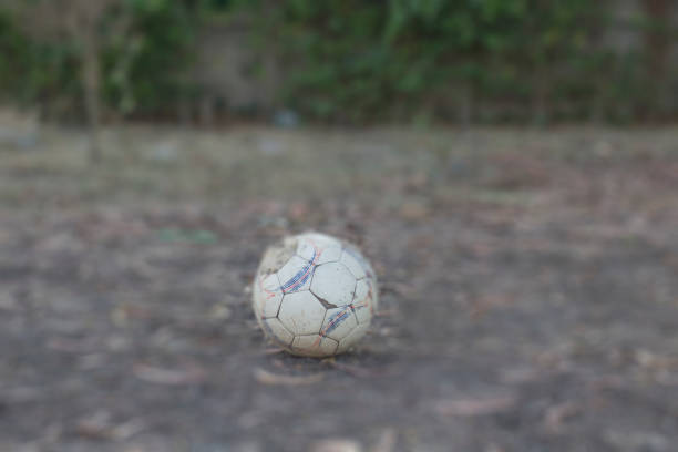 istock old football on the ground. 640258534