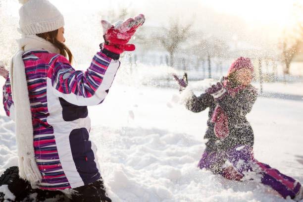 istock Happy kids playing in snow 640259870