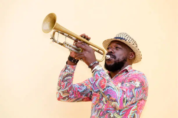 Cuban musician playing a trumpet outdoors, Havana, Cuba