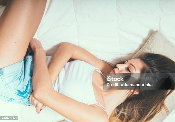 Woman Stomach Pain On Bed Top View Stock Photo - Download Image Now - Pain, Menstruation, Adult
