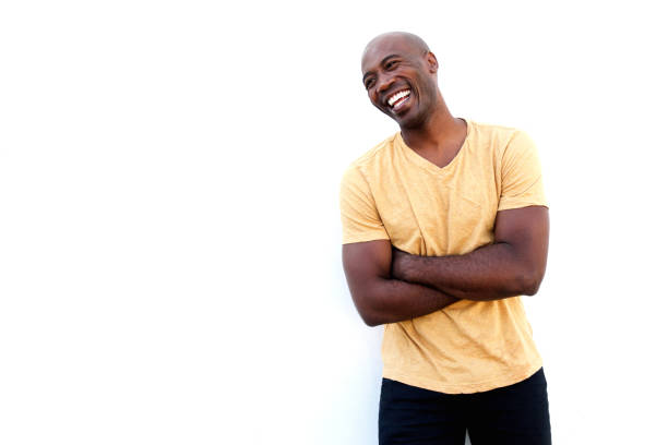 istock Laughing black guy standing with arms crossed 640261644