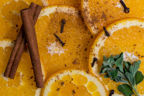 istock Orange fruit with cinnamon on wooden texture background 640262586