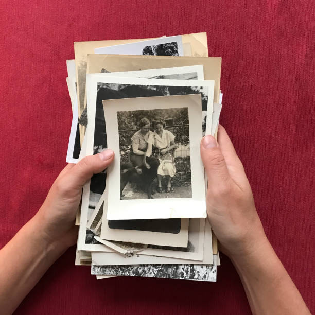 istock Hands Holding Stack of Old Photographs 640263472