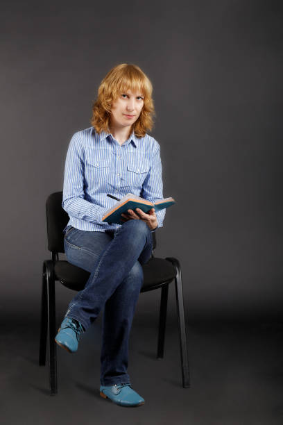 istock Woman sitting on a chair and writing in notebook. 640263500