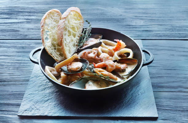 istock Seafood Stew in Saucepan on dark wood background 640264736