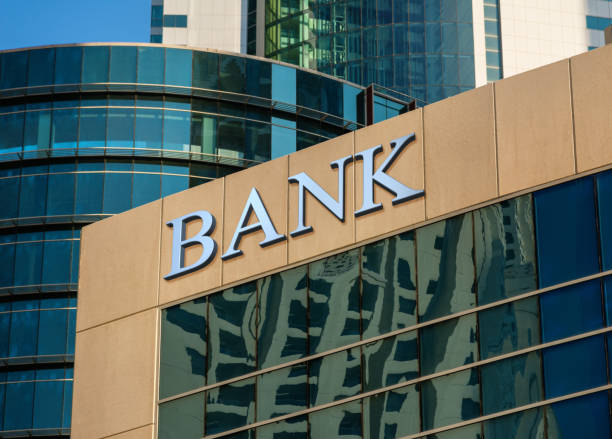 Bank building Bank sign on glass wall of business center bank entrance stock pictures, royalty-free photos & images