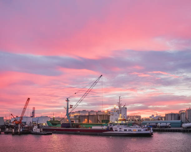 Loading operations during in sea harbour with barges and cranes stock photo