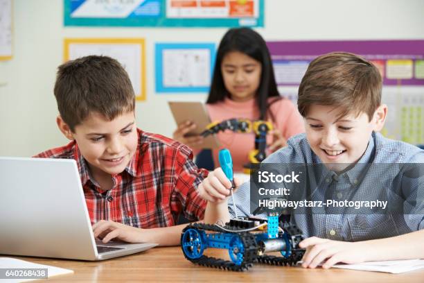 Pupils In Science Lesson Studying Robotics Stock Photo - Download Image Now - Robot, Child, Robotics