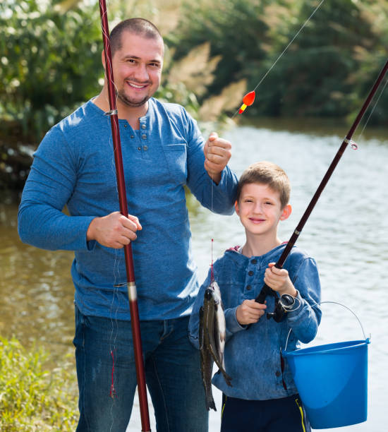 istock Glad father and son fishing with rods 640269012