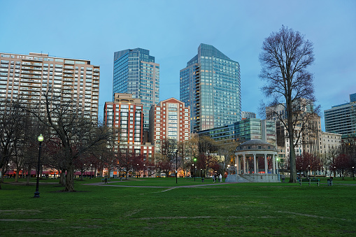 Boston, United States - April 27, 2015: Skyline and Boston Common public park in downtown Boston, Massachusetts, the United States. People on the background. Late in the evening