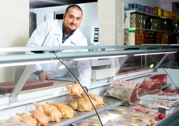 Male seller in halal section at supermarket Portrait of happy male seller in halal section at supermarket halal stock pictures, royalty-free photos & images