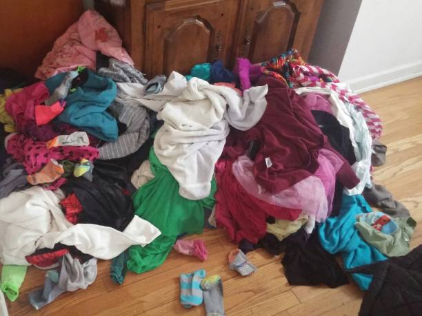 istock Girls Dirty Clothes Laundry Piled on Floor 640269724