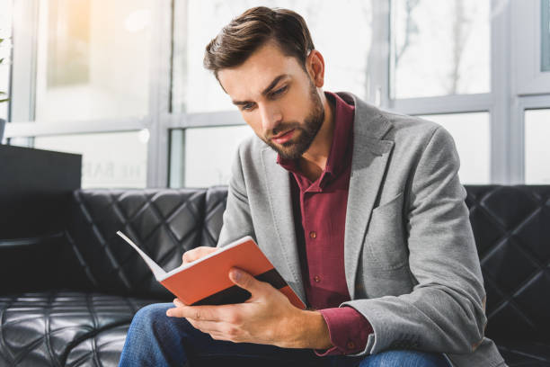 istock Pensive businessman making notes in writing-pad 640269778