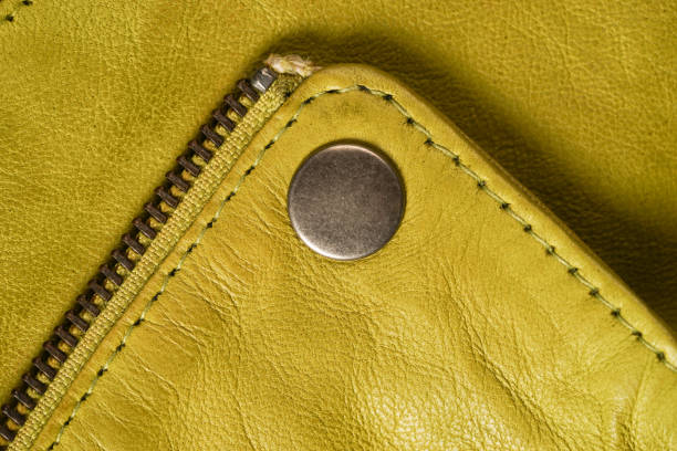 istock Metal clasp button on yellow leather jacket. macro detail 640270130