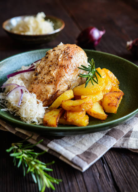 istock Roasted chicken breast with potato, steamed sour cabbage and onion 640272016