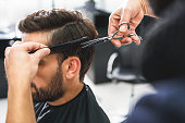 istock Barber using scissors and comb 640274128