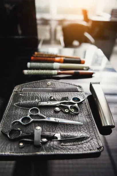 Photo of Set of hair clippers and hairbrush on table