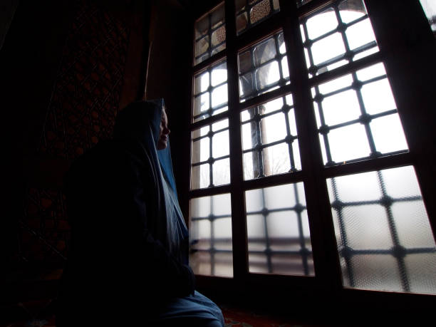 istock Muslim girl, praying by window light 640280234