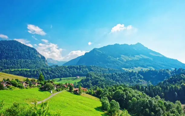 Panoramic view on Chalets on Prealps mountains in Gruyere district, Canton Fribourg in Switzerland