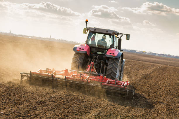 istock Farmer in tractor preparing land with seedbed cultivator. 640280606