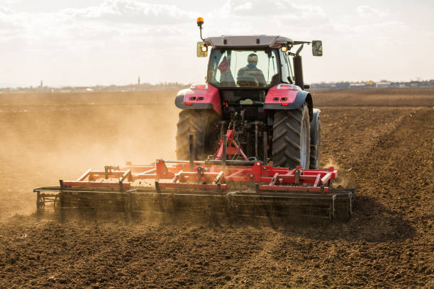 istock Farmer in tractor preparing land with seedbed cultivator. 640280726