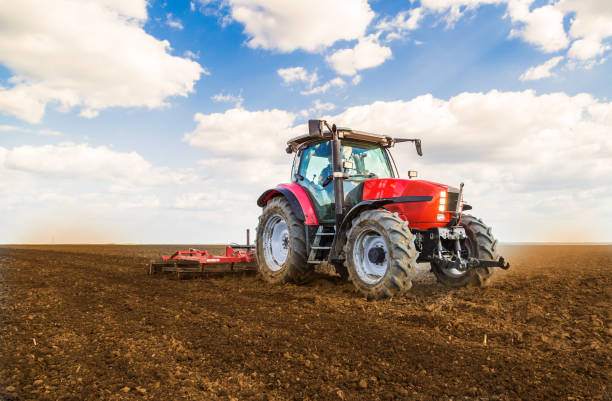 istock Farmer in tractor preparing land with seedbed cultivator. 640281256