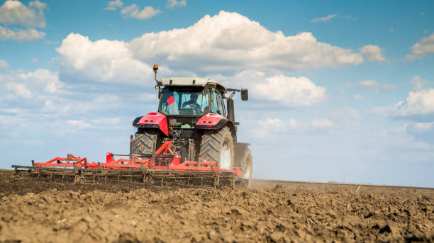 istock Farmer in tractor preparing land with seedbed cultivator. 640282660