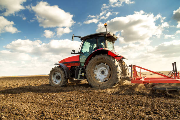 istock Farmer in tractor preparing land with seedbed cultivator. 640284868