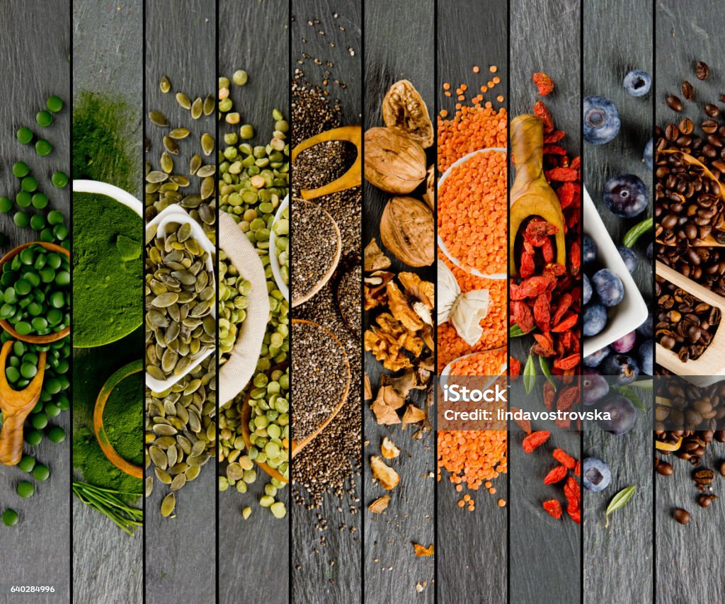 Superfood Mix Stripes Top view of mixed colorful superfoods scattered on gray slate tile surface Food Stock Photo