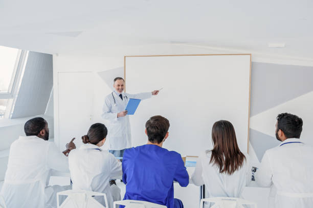 istock Senior professor of medicine working with students 640285826