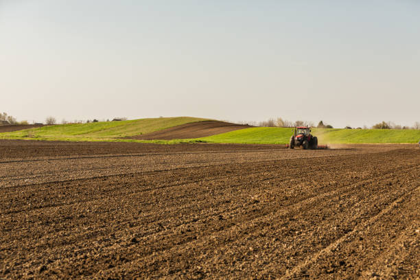 istock Farmer in tractor preparing land with seedbed cultivator. 640286738