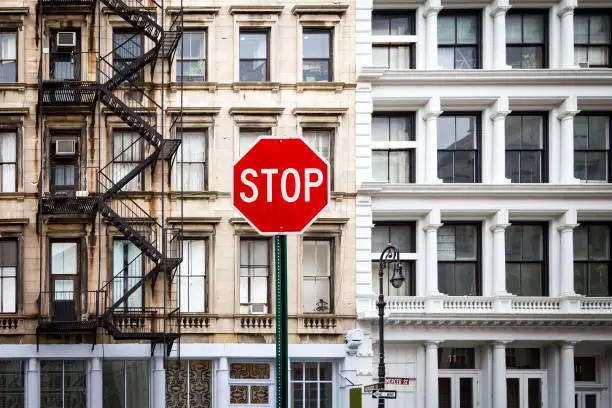 Photo of Stop Sign Near Old Buildings in New York City