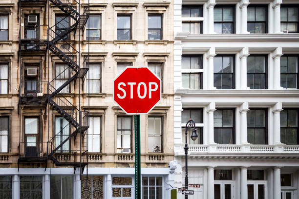 стоп-знак возле старых зданий в нью- - one way stop stop sign street стоковые фото и изображения