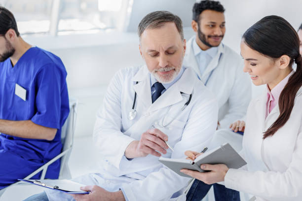 istock Experienced doctor undersigning papers at hospital 640287508