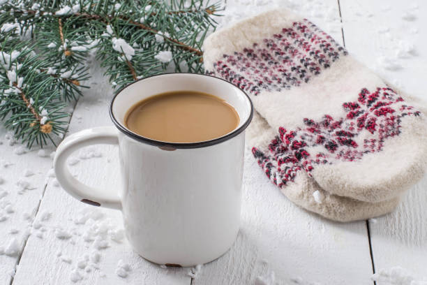 istock Hot chocolate in a mug and warm knitted mittens 640287926