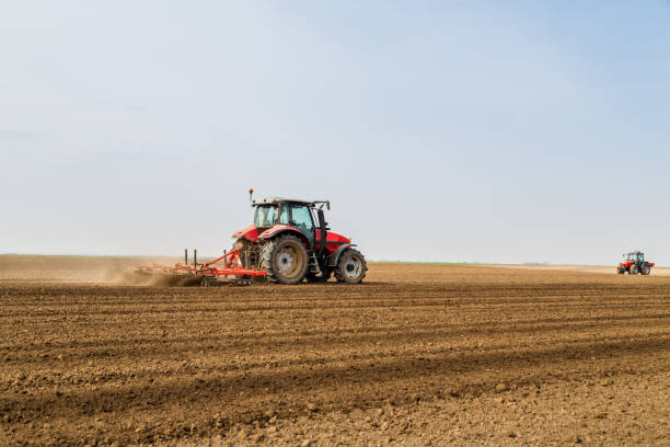 istock Farmer in tractor preparing land with seedbed cultivator. 640289174