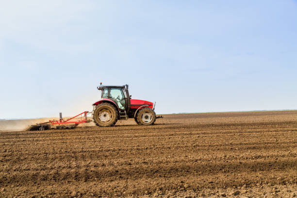 istock Farmer in tractor preparing land with seedbed cultivator. 640289238