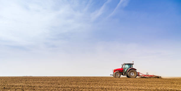istock Farmer in tractor preparing land with seedbed cultivator. 640289664