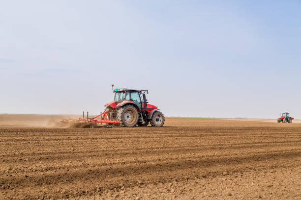 istock Farmer in tractor preparing land with seedbed cultivator. 640289804