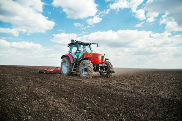istock Farmer in tractor preparing land with seedbed cultivator. 640289916