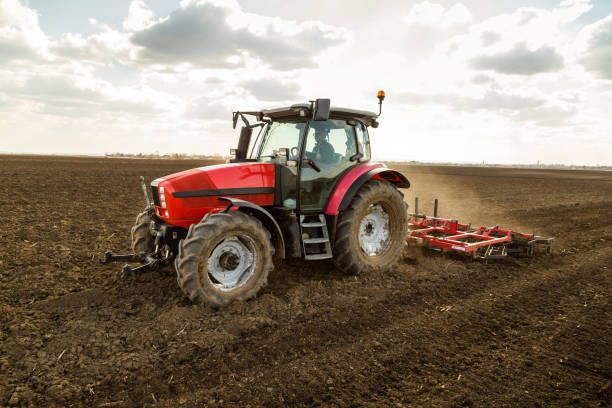 istock Farmer in tractor preparing land with seedbed cultivator. 640290558