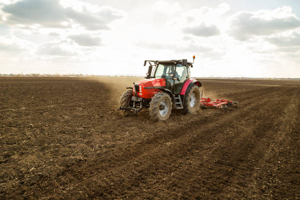 istock Farmer in tractor preparing land with seedbed cultivator. 640290636