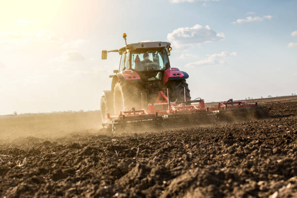 istock Farmer in tractor preparing land with seedbed cultivator. 640290836